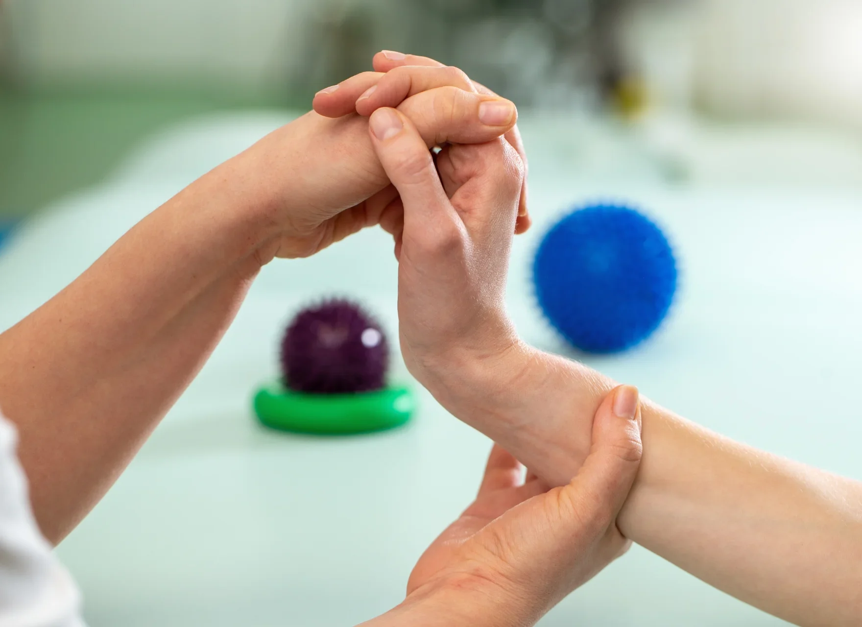 hand being manipulated with therapy balls nearby 2026 01 06 10 56 43 utc e1777515595318